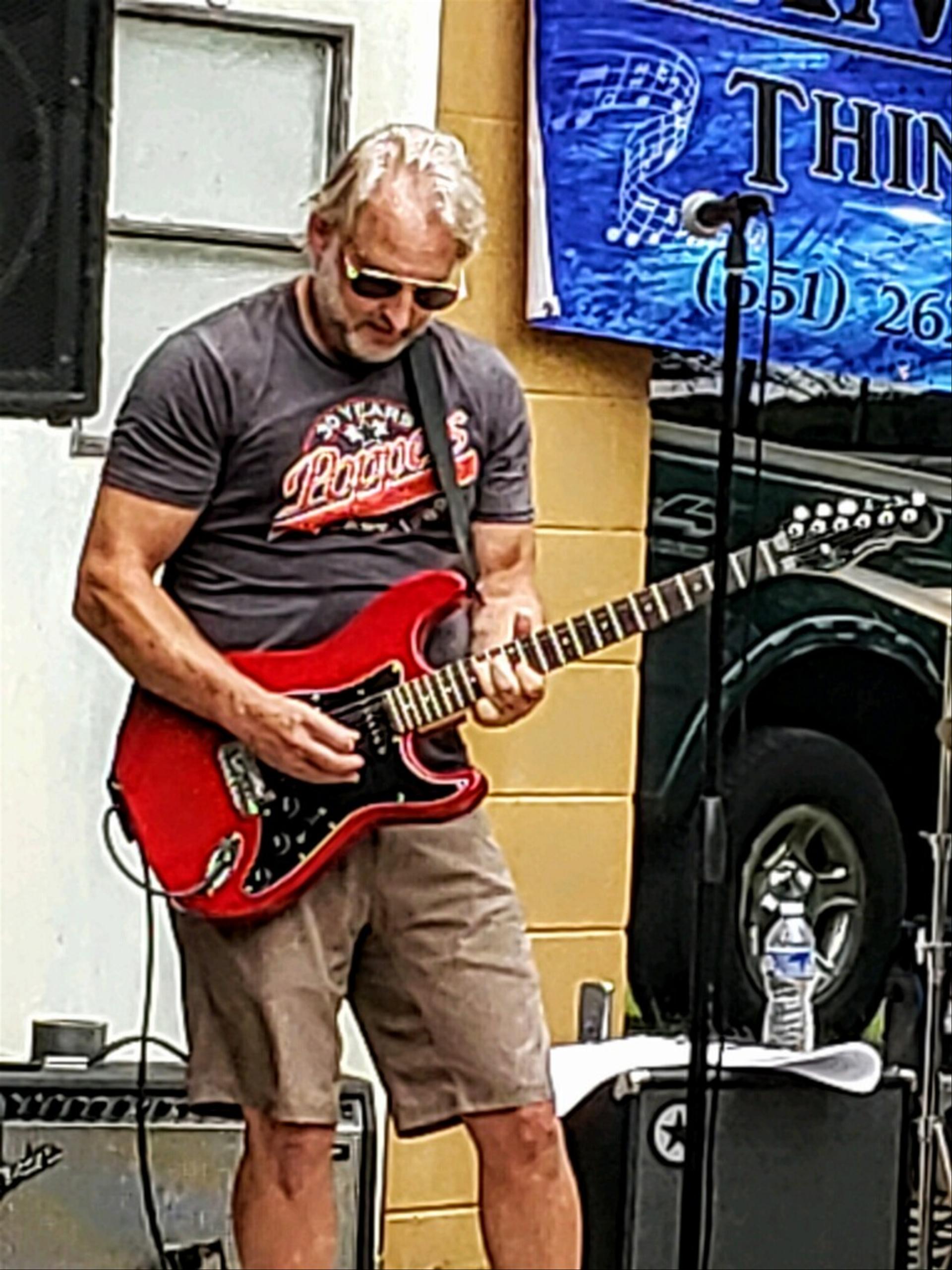 Steve, Ranger Things's guitarist, playing a solo during a live performance